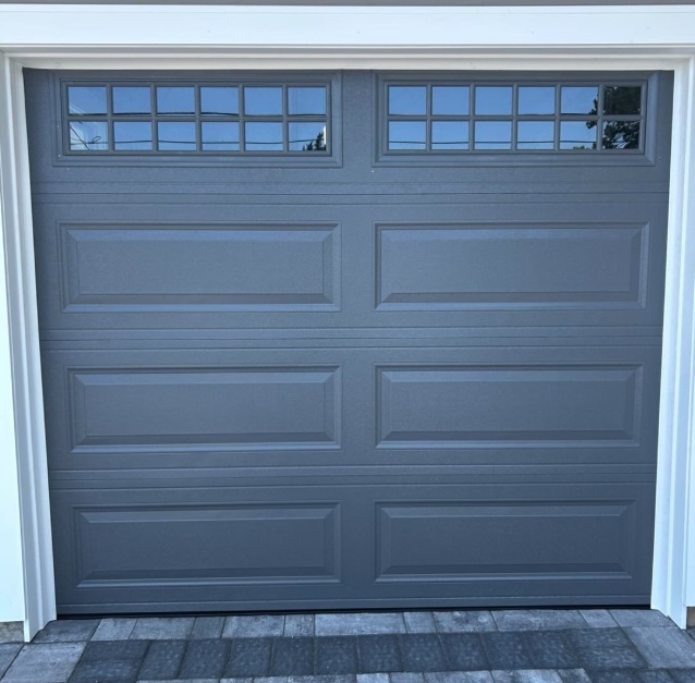 New insulated charcoal gray raised-panel garage door with divided-lite windows, installed by Surfside Garage Doors in Ocean County, New Jersey.