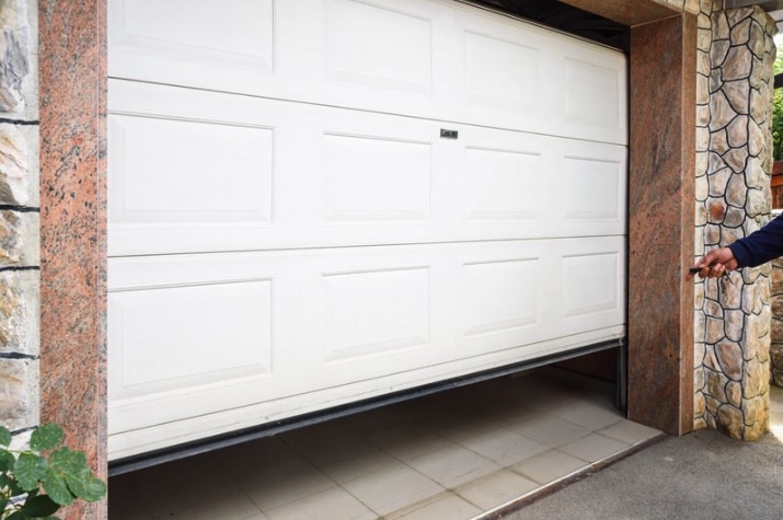 Partially open garage door in a Toms River home showing a misaligned bottom panel, illustrating a common off-track issue Surfside Garage Doors repairs across Ocean County.